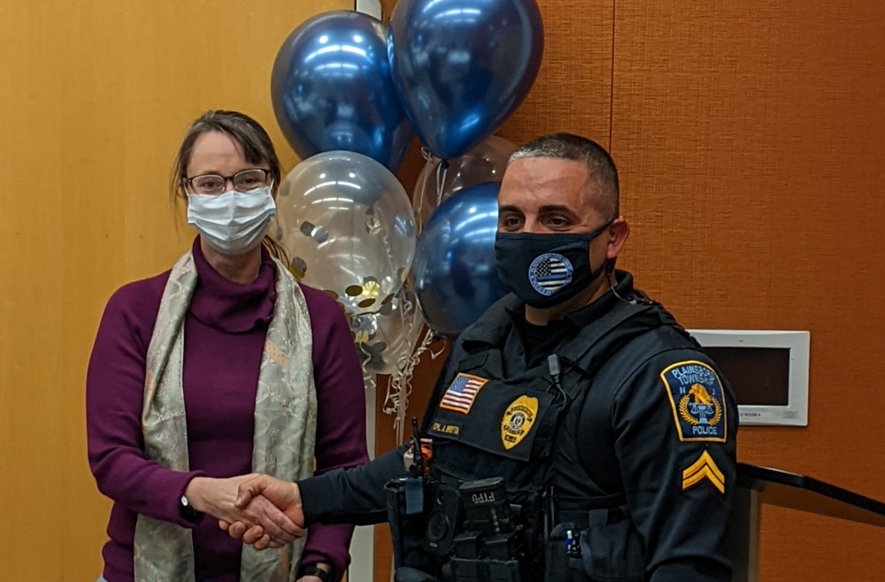 Plainsboro Police Cpl. Joseph Breyta (right) presents the Life Saving Award to Kim Giese, RN, of the Center for Critical Care at Princeton Medical Center.